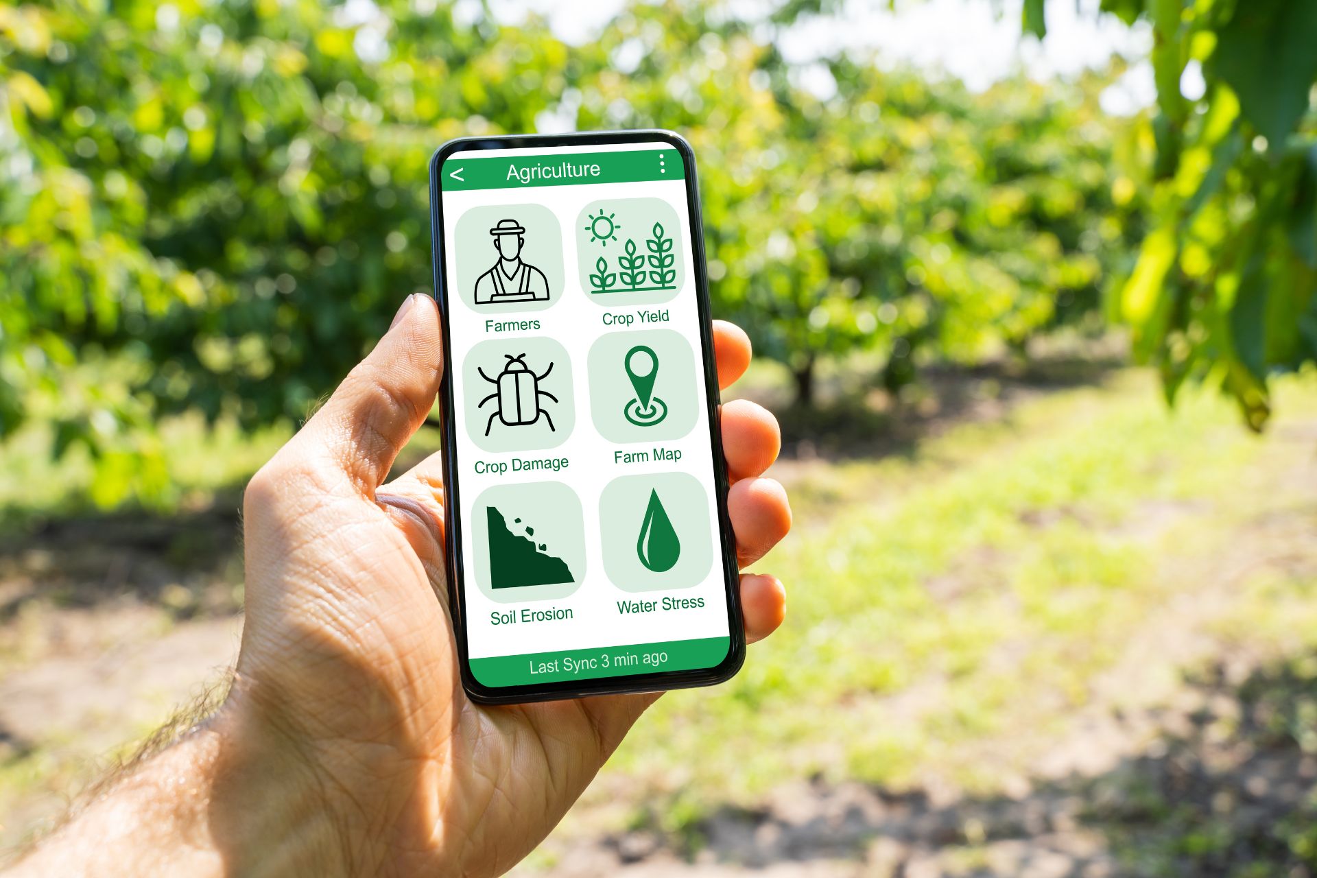 a photo of a hand holding a smart phone with agricultural data on it