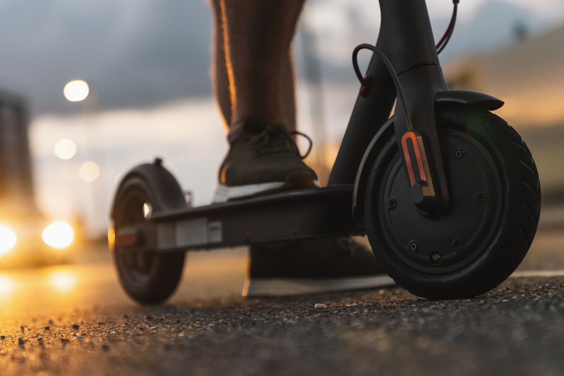 a photo of a person standing on an electric scooter